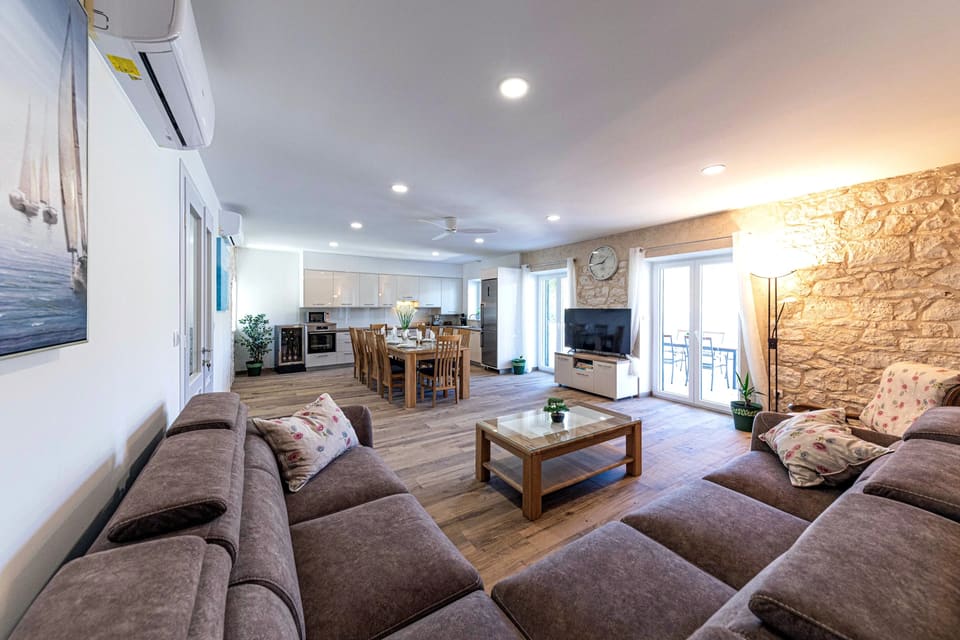 Living room with exposed stone wall