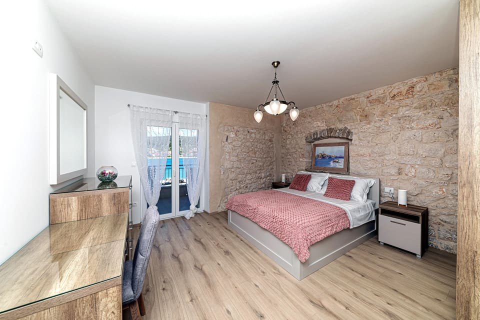Bedroom with exposed stone wall