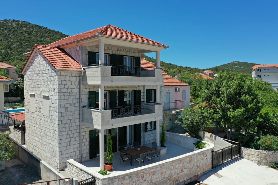 Stone facade with three floors of seaview balconies